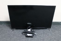 A Samsung 32" Smart TV with lead and remote