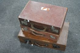 Three antique leather luggage cases