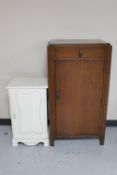 A 1930's oak single door cabinet fitted with a drawer together with a painted Victorian pot