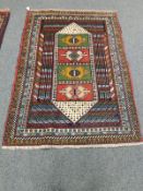 A Caucasian rug on polychrome ground,
