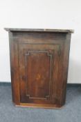 A George III inlaid oak corner cupboard