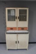 A mid twentieth century kitchen cabinet