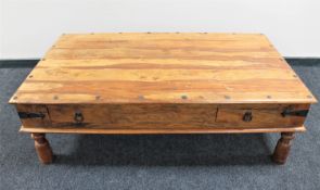 A sheesham wood coffee table fitted two drawers