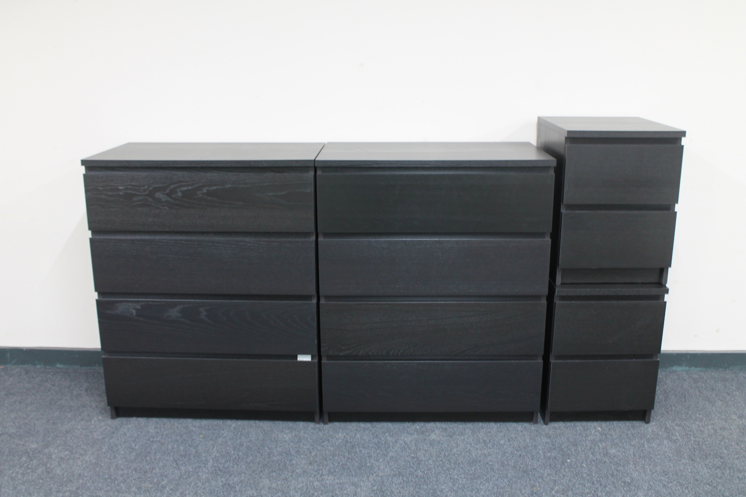 A pair of Ikea black ash four drawer chests and a pair of bedside chests