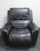 A brown leather Lazy Boy manual reclining armchair