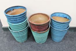 Seven glazed earthenware plant pots