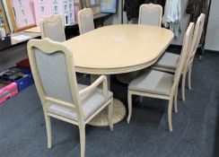 A large oval pine twin pedestal extending table and six chairs