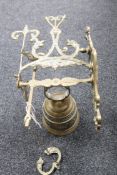 A cast brass wall bracket with bell