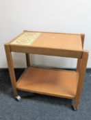 A teak Nathan Furniture two tier trolley inset tiled panel