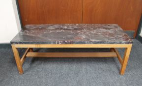 A rectangular marble topped coffee table on teak legs