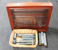 A display case together with a wicker basket containing Hornby and Lima 00 gauge engines