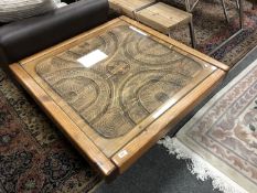 A carved pine low table with glass top,