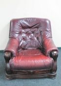 A wood framed Burgundy leather armchair