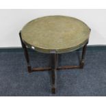 A circular Eastern brass topped table