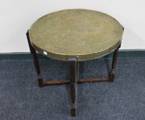 A circular Eastern brass topped table