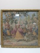 A gilt framed tapestry panel depicting figures in eighteenth century dress dancing