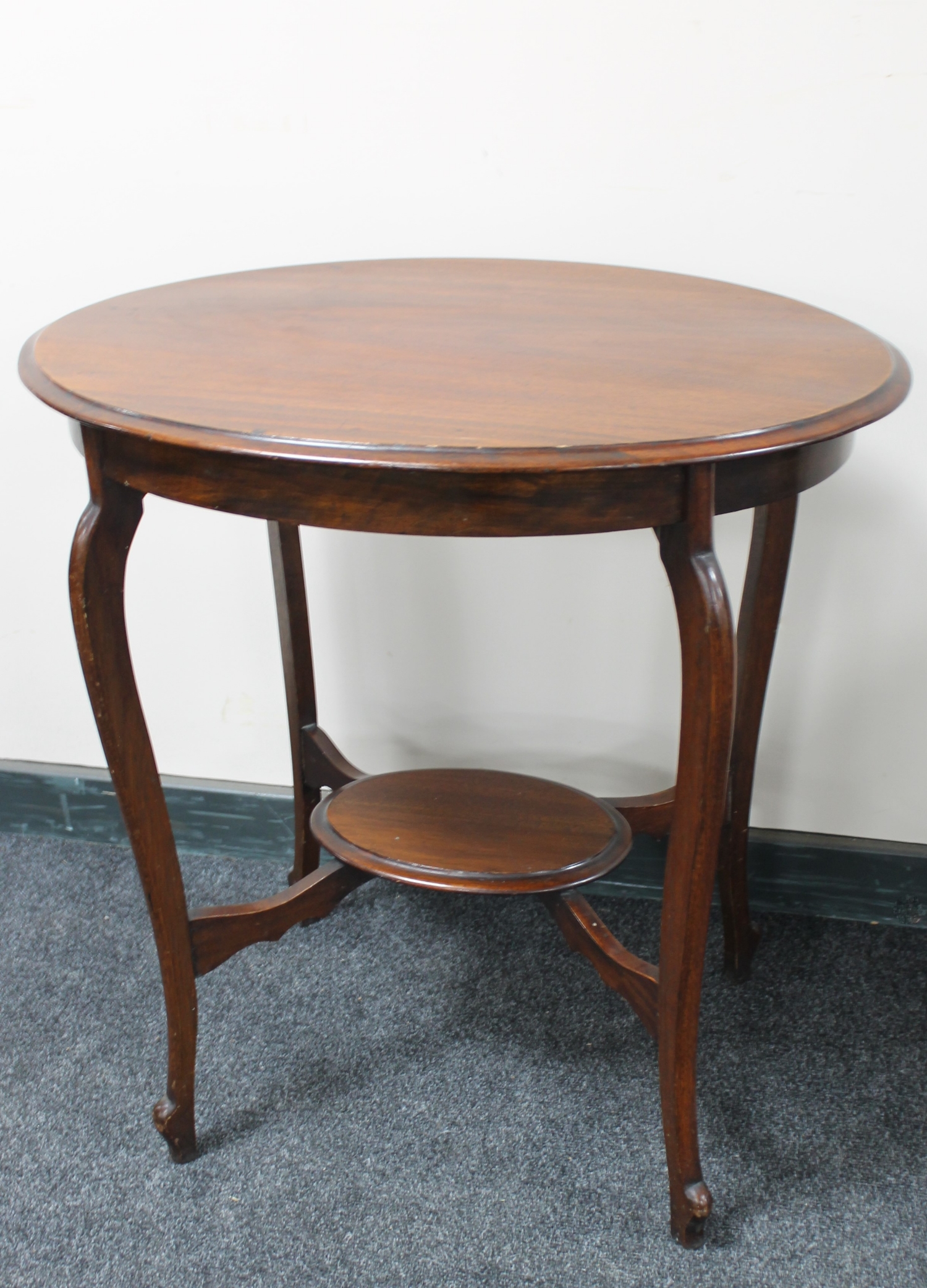 An Edwardian mahogany oval occasional table