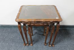 A nest of three stained beech tables