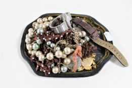 A small oriental style tray containing costume jewellery,