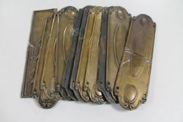 Eleven various antique brass door plates