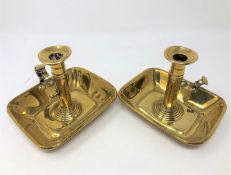 A pair of early nineteenth century brass rise and fall chambersticks.