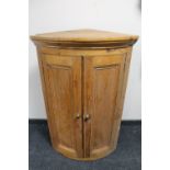 A Victorian pine double door bowfront corner cabinet