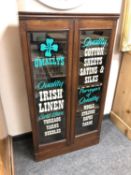 An Edwardian and later glazed cabinet "Irish Linen",