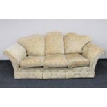 A three seater settee upholstered in gold classical brocade fabric