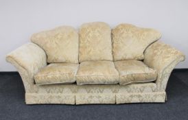 A three seater settee upholstered in gold classical brocade fabric