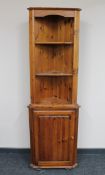 A pine corner cabinet fitted a cupboard