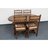 An oval extending dining table and four chairs