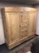 An antique pine compactum double door wardrobe,