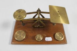 A set of antique brass postal scales with weights