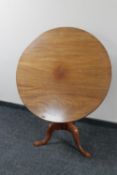 A Victorian tilt top pedestal table