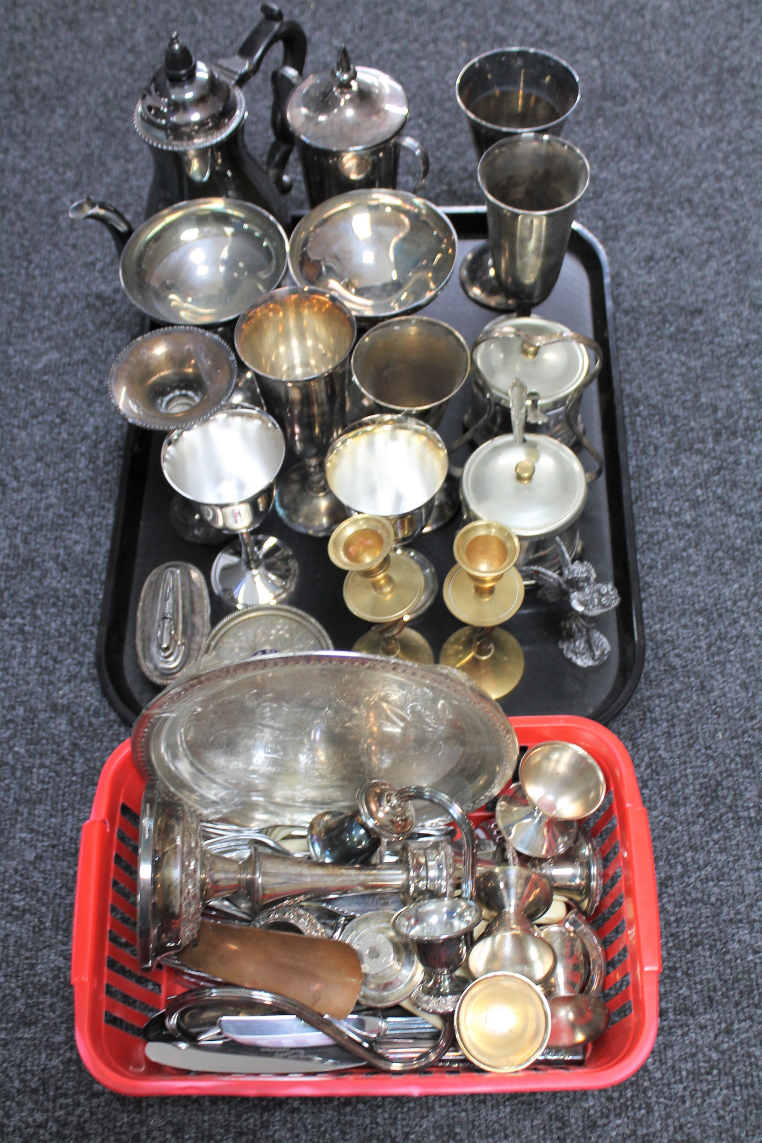 A tray of plated and metal items, goblets, champagne flutes, brass candlesticks, table lighter,