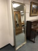 A tall silvered rectangular mirror,