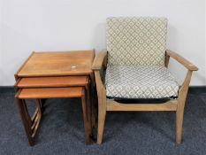 A nest of teak G Plan tables and a teak armchair