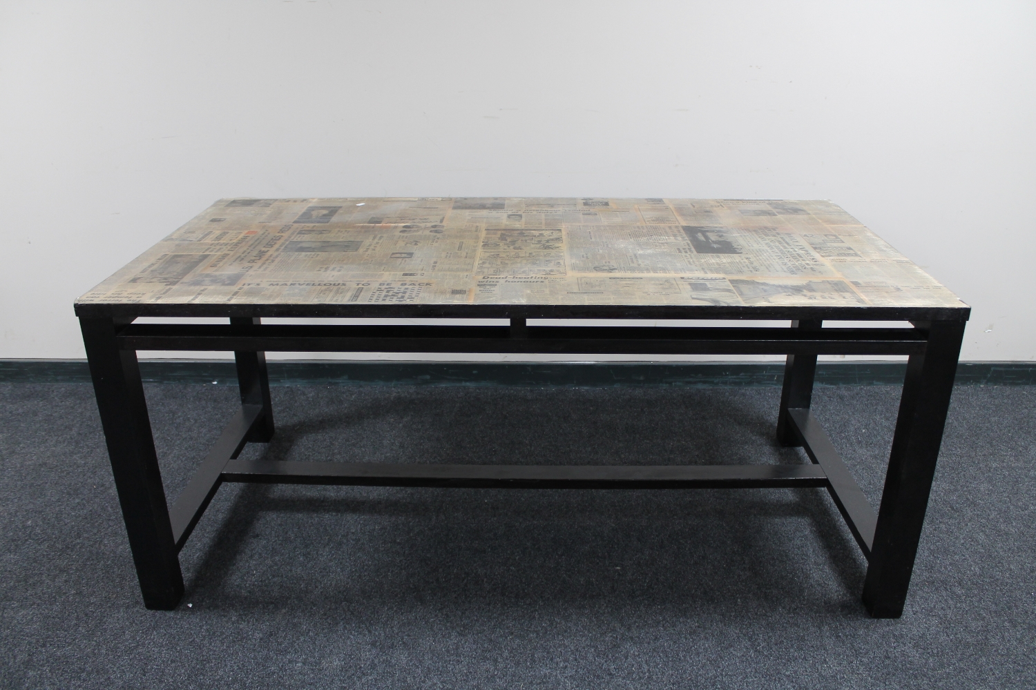 A contemporary dining table with 'newspaper' top