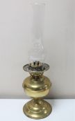 An early twentieth century Duplex brass oil lamp with glass chimney