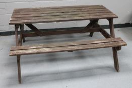 A wooden garden table with benches