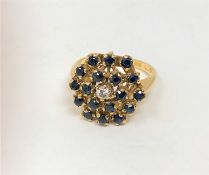 An 18ct gold sapphire and diamond cluster ring