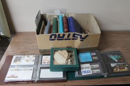 A box of loose stamps, stamp albums and stamps,