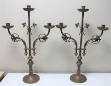 A pair of decorative copper three way church candlesticks