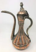 A nineteenth century Persian copper and silvered metal Dallah, height 38.5 cm.