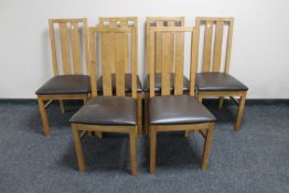 A set of six contemporary leather seated rail back chairs