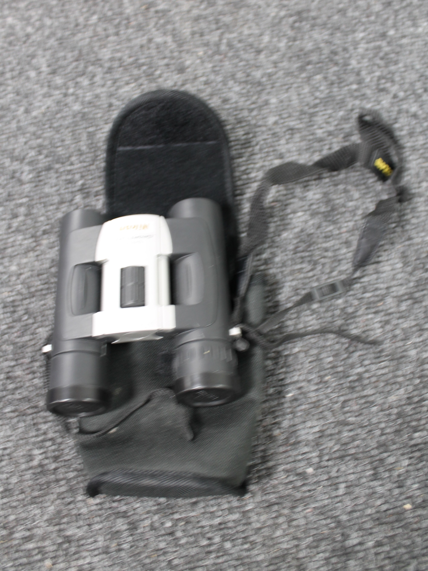 A pair of cased Nikon sport lite 10x 25 binoculars