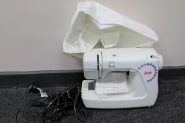 A Janome sewing machine with foot pedal