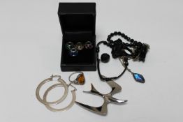 Two boxes of silver jewellery : charms, butterfly wing pendant on chain, silver and amber ring,