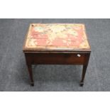 An Edwardian mahogany piano stool