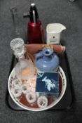 A tray of glass bottle, glass decanter with glasses, Newcastle Brown Ale tray and towel,